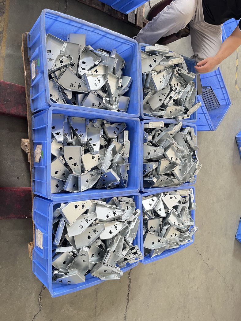 Stamped parts in bins, ready for the next operation.