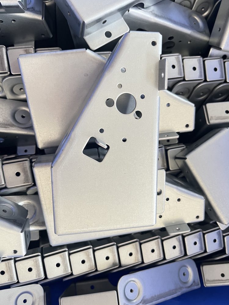 Stamped hinge plates in crates.