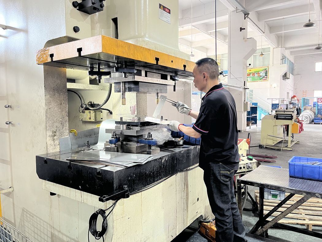 Operator loading a press.