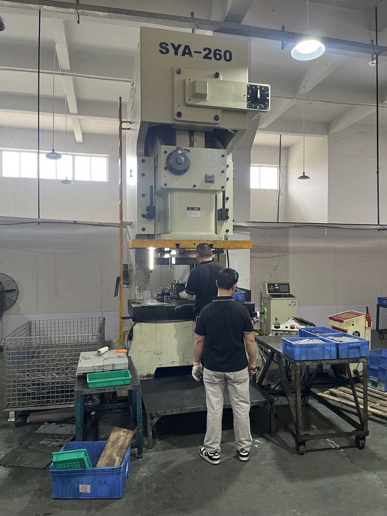 Two operators working at a press.
