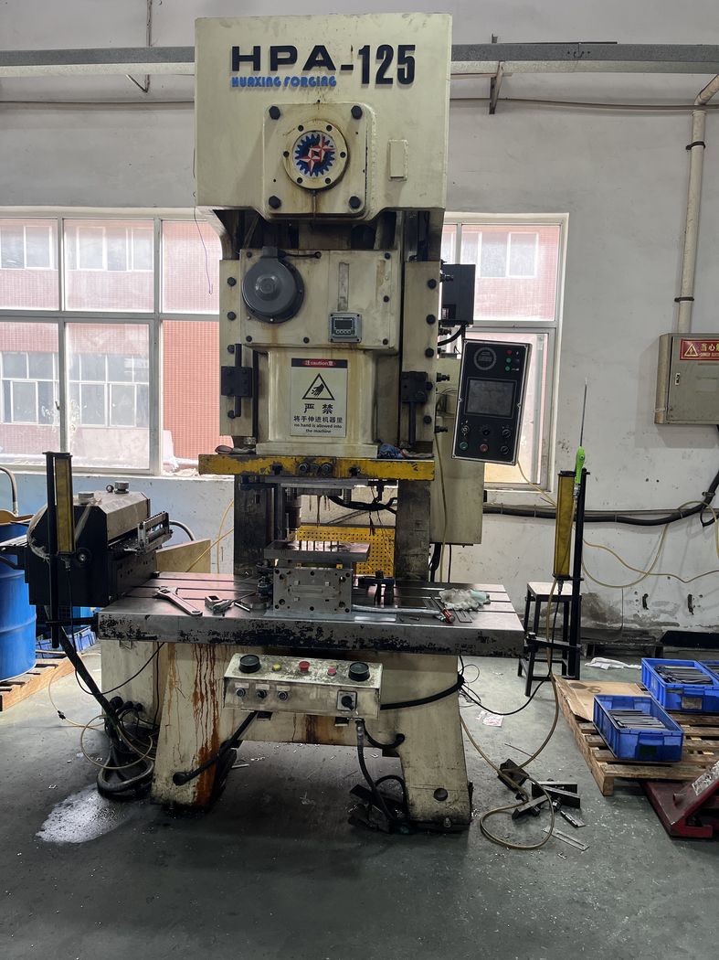Operator loading parts by hand.