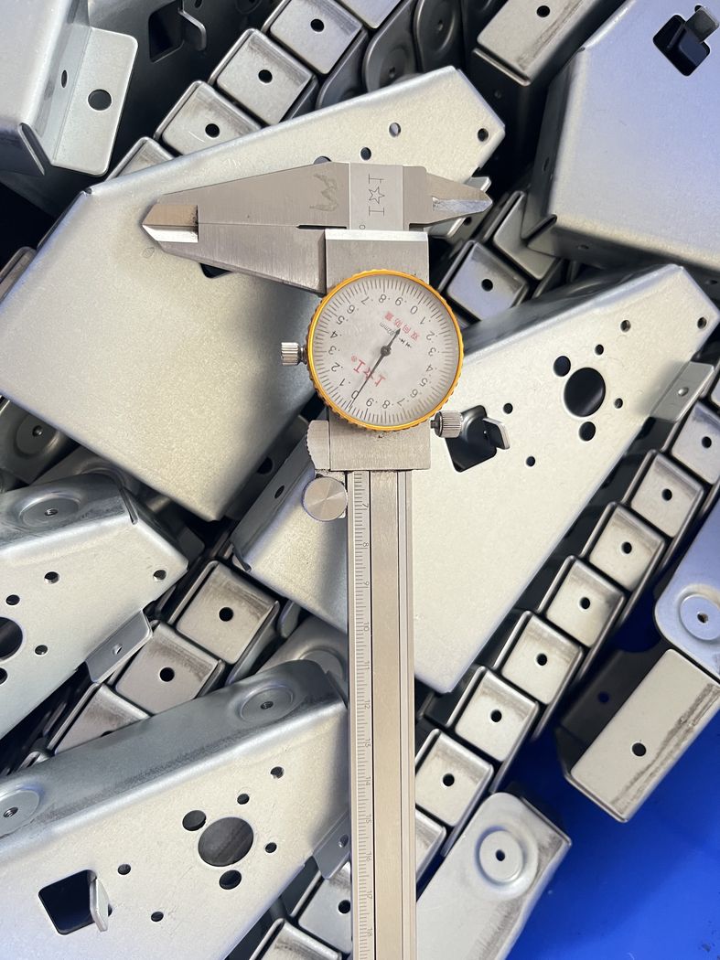 Dimensional checks with calipers and gauges.